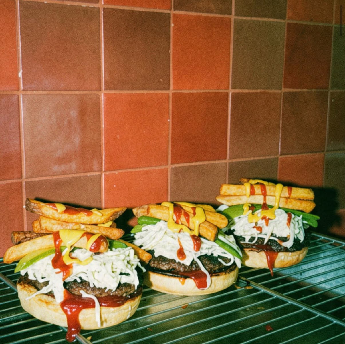 Burgers libanais garnis de frites alignés sur une grille
